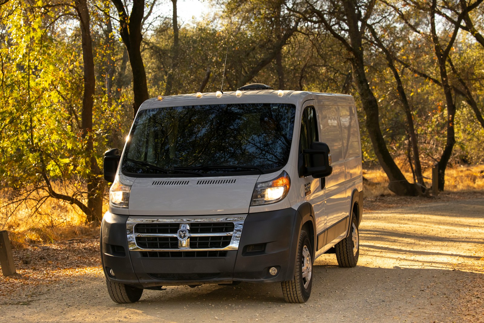 white and black mercedes benz van parked on gray concrete road during daytime, commercial auto